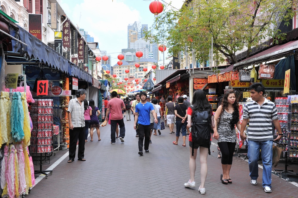 SINGAPORE - FEB 11: Shoppers walk through Chinatown as Singapore welcomes in Chinese New Year on Feb 11, 2012 in Singapore. The city state's ethnic Chinese began settling in Chinatown circa 1820s.