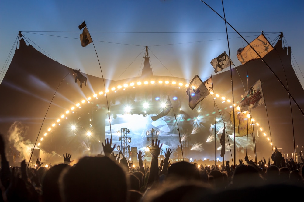 ROSKILDE, DENMARK - JULY 2 Audience with flags and banners, raising their hands in front of the stage at Roskilde Festival 2015. Roskilde Festival is one of the largest music festivals in Europe.
