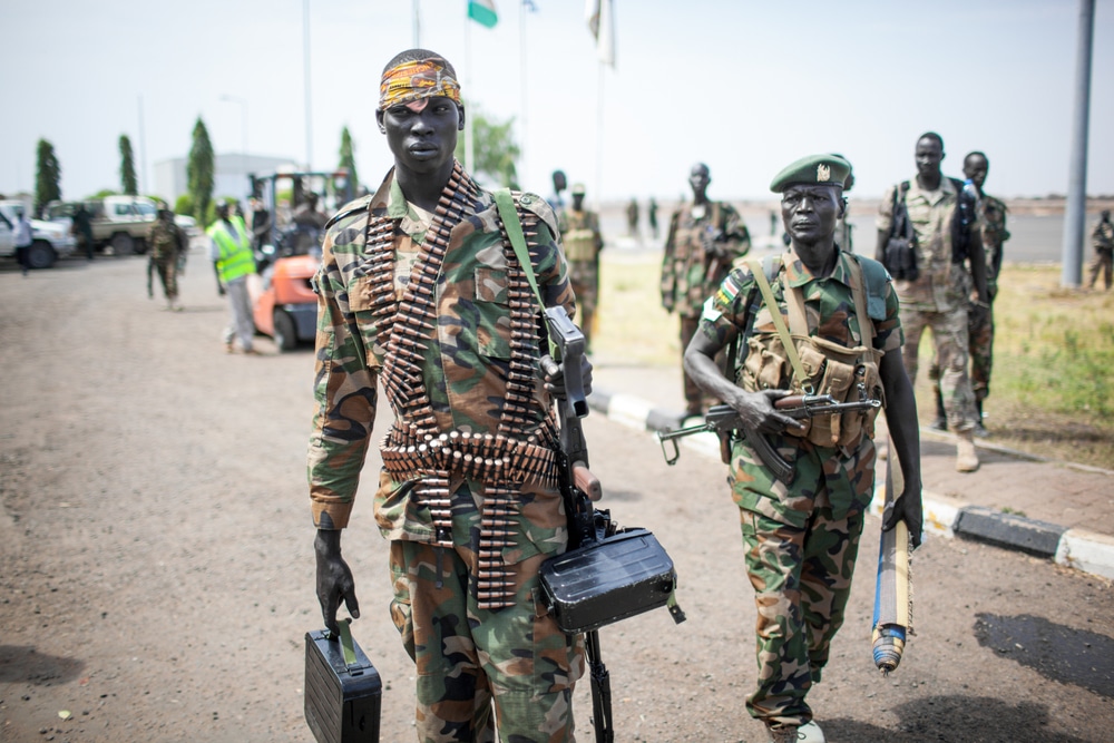 Paloch, South Sudan - March 2, 2014: A South Sudanese soldier carries a machine gun