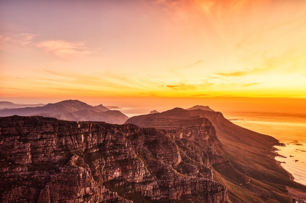Cape Town Sunset Aerial View from Table Mountain over Camps Bay, Lion's Head and Twelve Apostles in the Background, South Africa