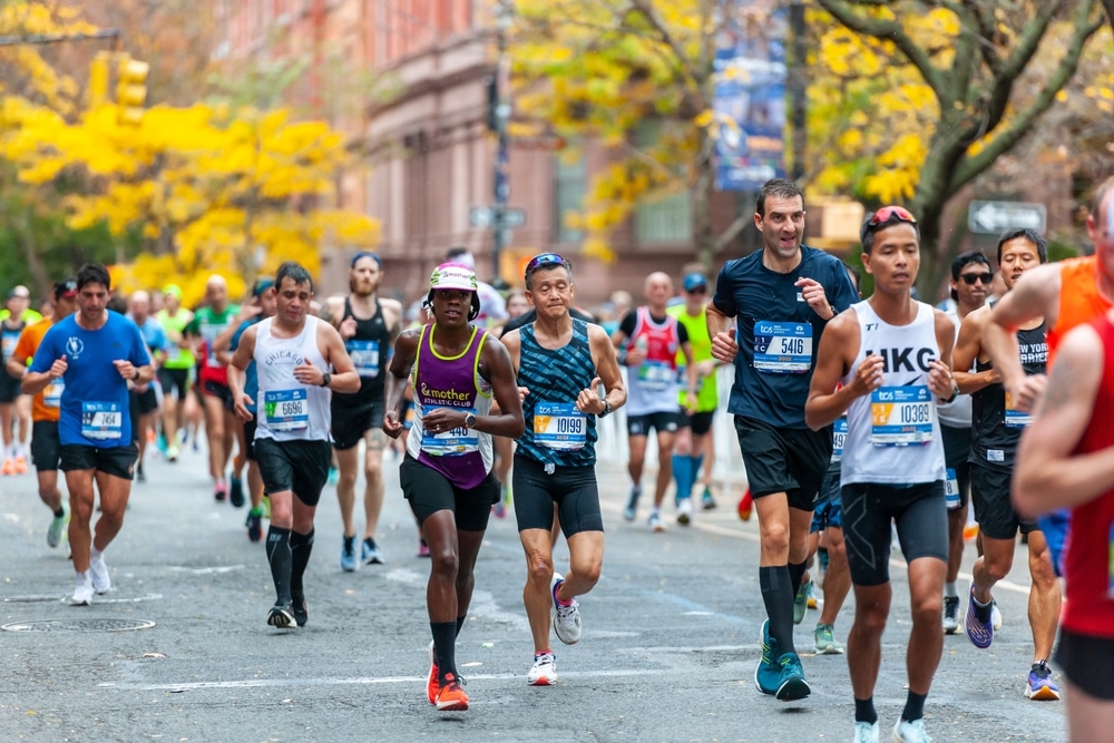 New York NY USA-November 6, 2022 Runners pass through Harlem in New York near the 22 mile mark near Mount Morris Park in the running of the TCS New York City Marathon