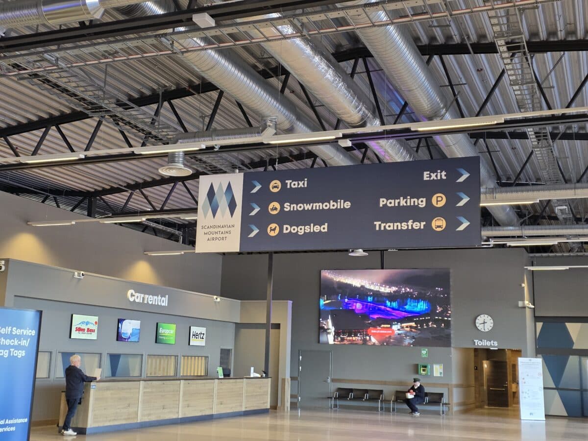 transfer sign at Dalarna airport includes snowmobile and dog sled