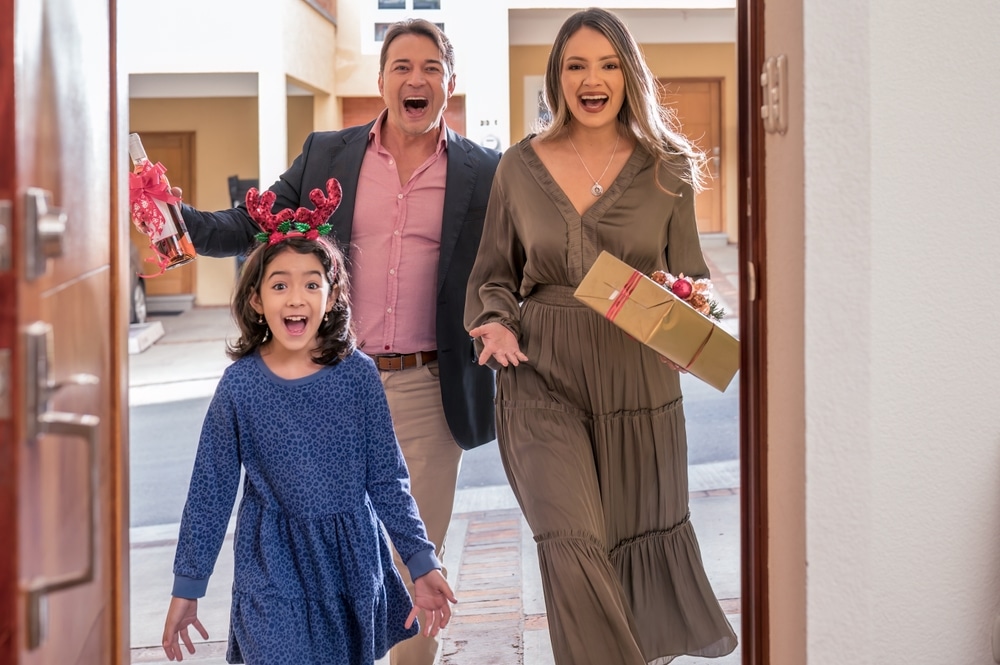 Family entering their friends house to celebrate the seasonal holidays.