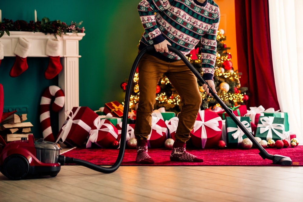 Festive preparation at home with cheerful mood during Christmas holiday near decorated tree and bright gift boxes