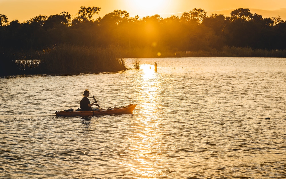 Pasadena, TX, US - Nov 11, 2017: Kayaker paddles down Armand Bayou at sunset in Pasadena Texas