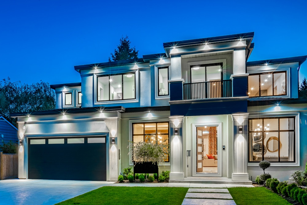 Beautiful contemporary white house with lush grass and blue sky twilight and daylight