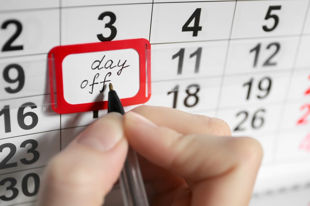 Woman marking day-off in calendar, closeup