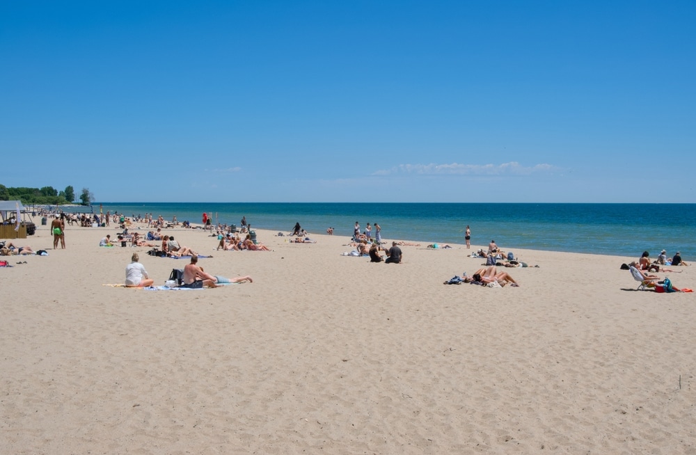 Bradford Beach, Wisconsin USA - June 14, 2024. A sunny and hot day with people relaxing on the beach by Lake Michigan near downtown Milwaukee.
