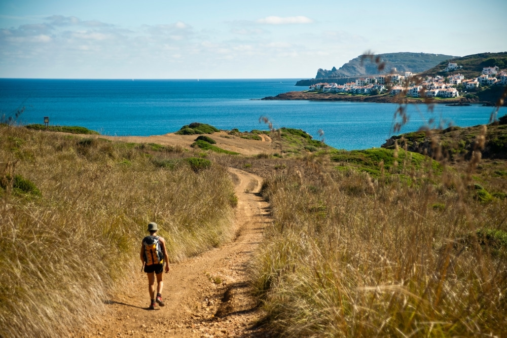 hiker on the path to Ferragut beach, horse trail, Menorca, Biosphere Reserve, Balearic Islands, Spain