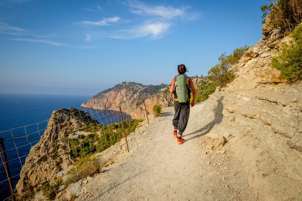 Hiker on the Es Portitxol path, Sant Joan de Labritja municipality, Ibiza, Balearic Islands, Spain
