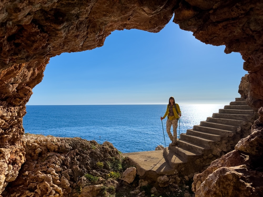 Tourist inside the sea cave with steps.