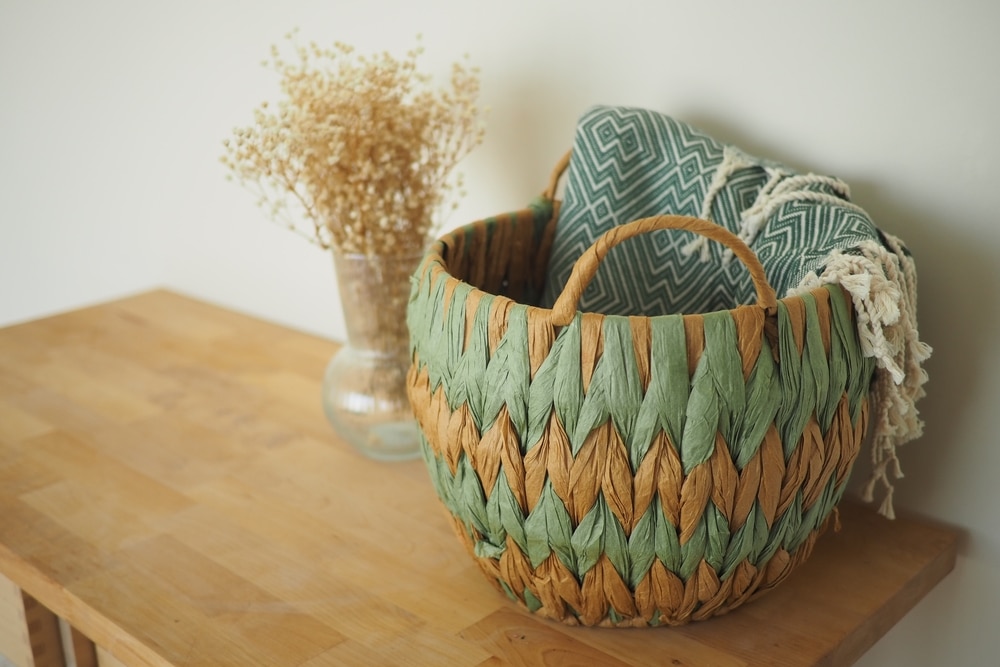 Woven basket and decorative items on wooden table