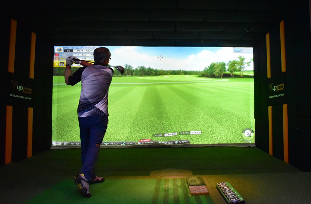 On August 24, 2017, a man is enjoying playing golf at T-up vision screen golf driving range in Jeonju, South Korea.