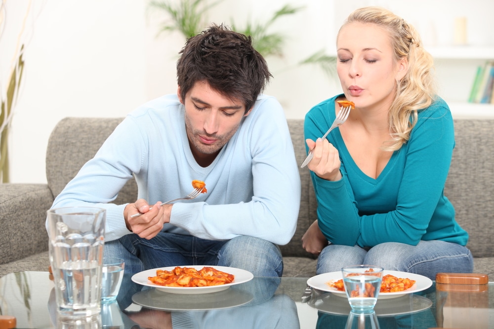 Couple eating meal at home
