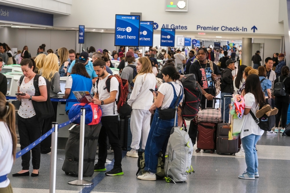 Holiday travelers wait in line to check-in at the Los Angeles International Airport in Los Angeles, Wednesday, June 28, 2023.