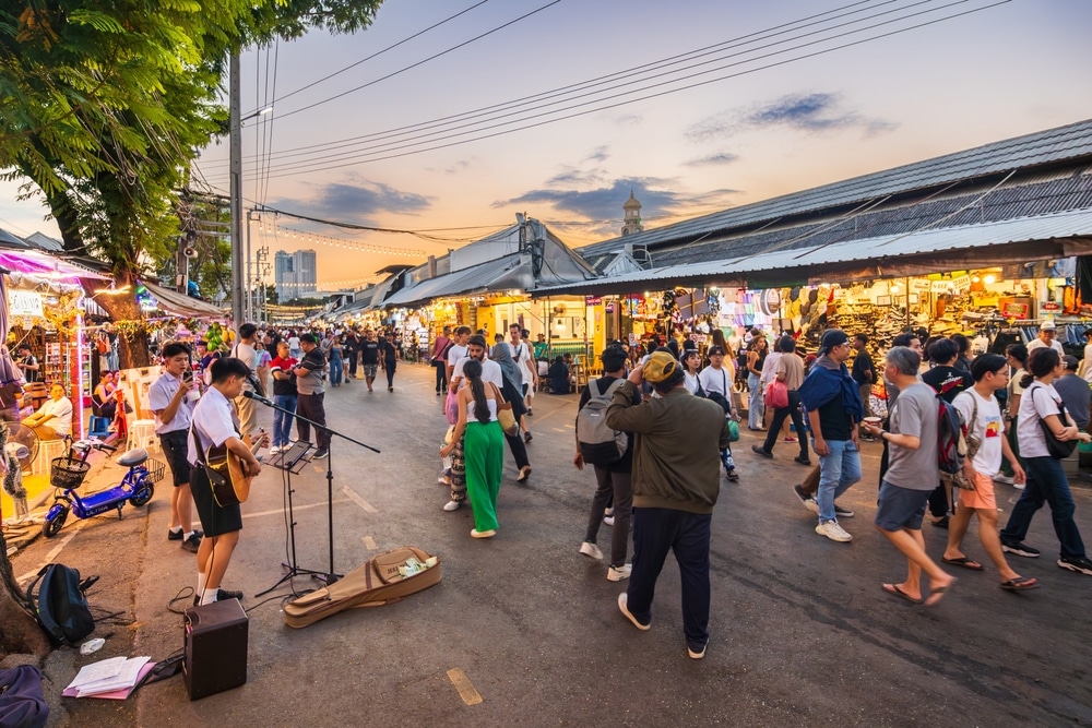 Bangkok, Thailand - December 16, 2023: Evening time At Chatuchak Market, witness young performers and street musicians showcasing diverse talents through busking and live performances.