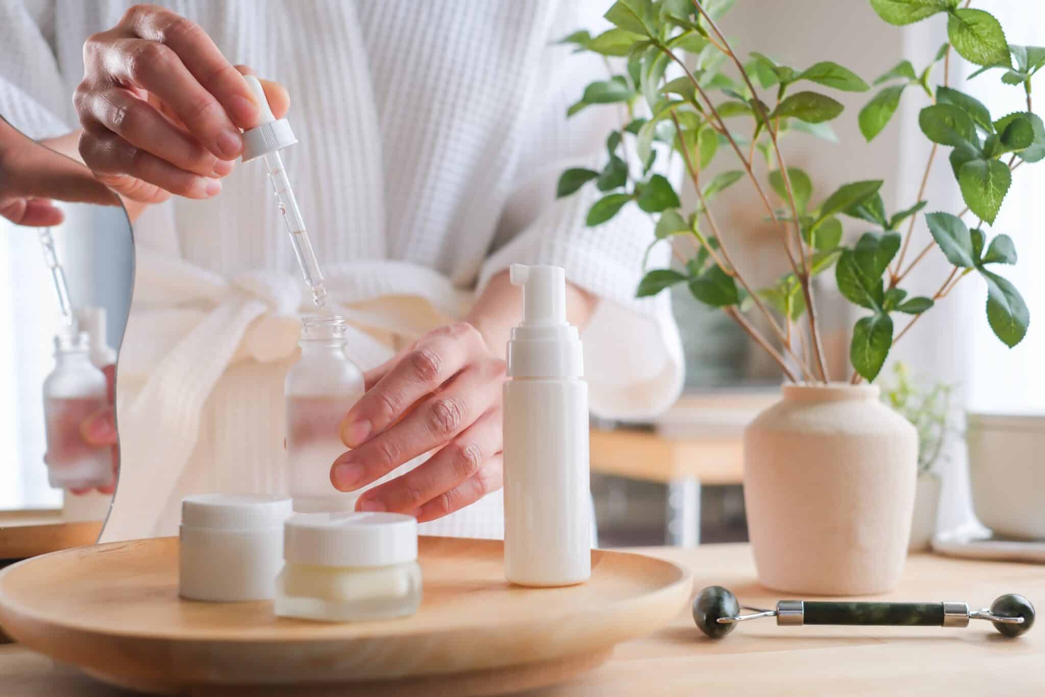 A woman applies skincare serum for beauty cosmetic, spa and wellness concept.