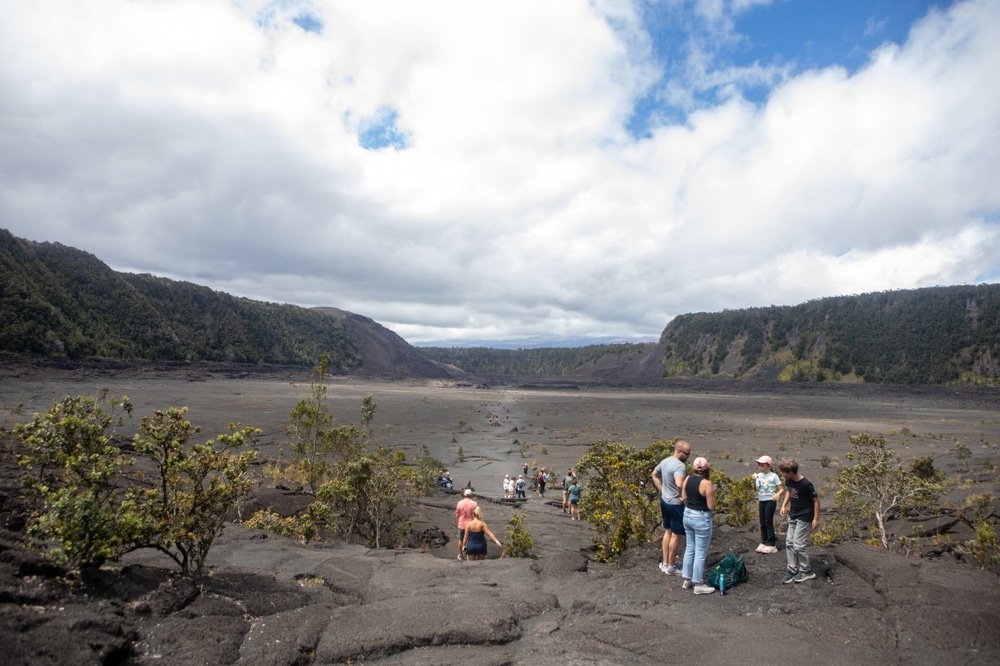 Hawai‘i Volcanoes National Park, Hawaii - October 4, 2024 - Visitors walk in the Kilauea Iki Crater on Kilauea volcano at Hawai‘i Volcanoes National Park on the Big Island of Hawaii.