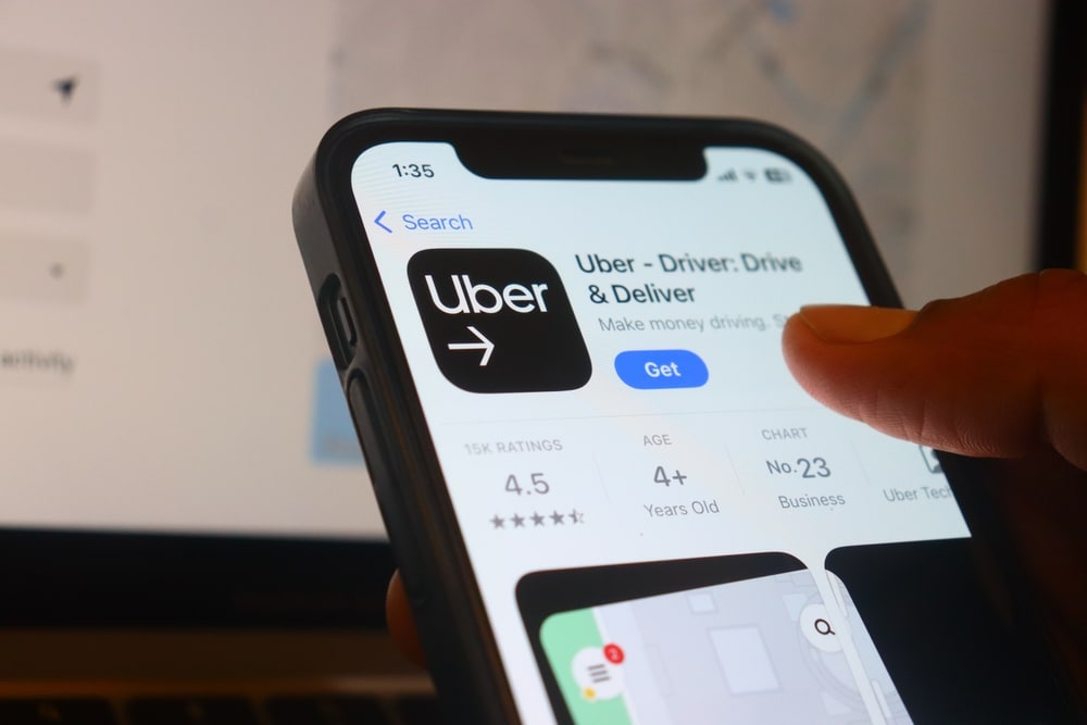 Hand holding iphone with Uber app.Uber is a ride-hailing service that connects passengers with drivers using a smartphone app
New Delhi, India, 20 May 2025