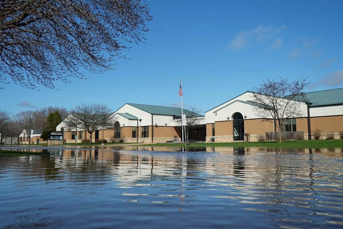 Photo of flooding in Shiocton, WI showing water almost up to the doors of the high school