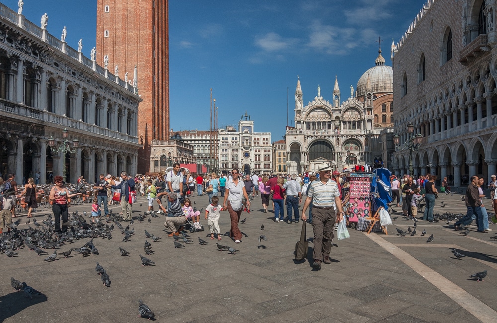Piazza San Marco, Venice, Italy -September 9, 2006: The main public, Renaissance architecture square in Venice with St. Marks's Campanile, Saint Mark's Basilica, Doge's Palace and many tourists