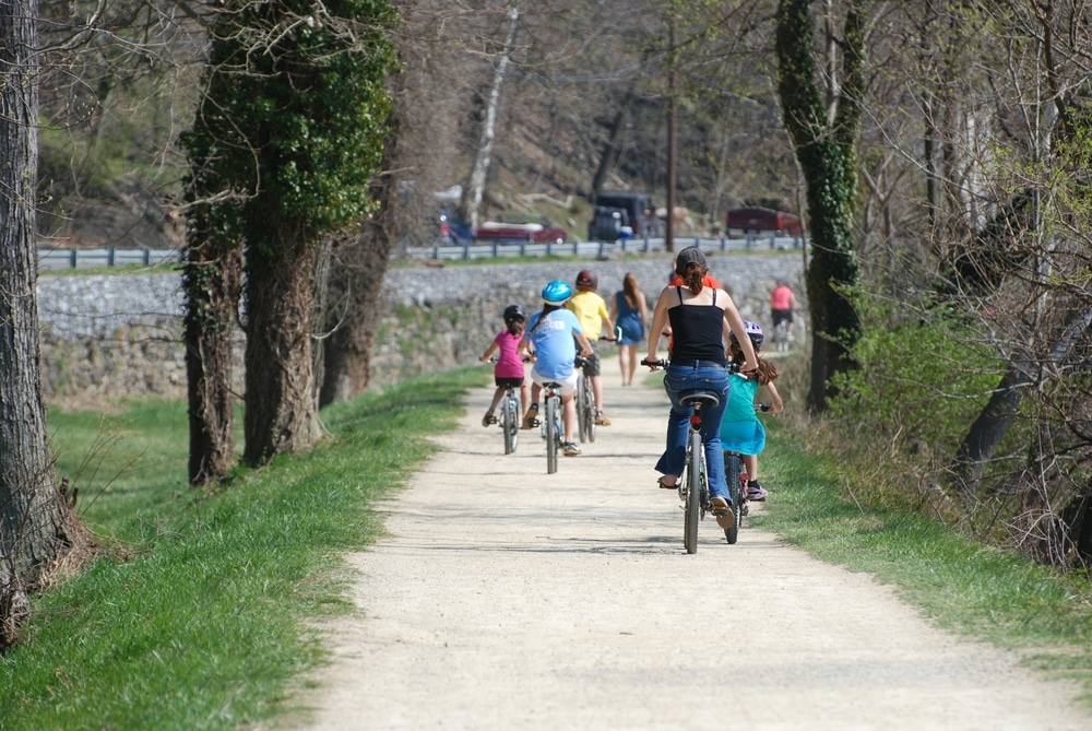 HARPERS FERRY, WV - APRIL 14, 2014: People walk, hike and ride bikes along the Chesapeake and Ohio Canal Towpath which runs along the Potomac River.