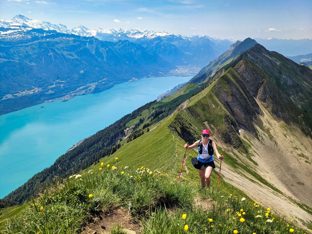 Young woman runs over the Hardergrat above Lake Brienz. Mountain mountain ridge extreme trail running in switzerland. High quality photo