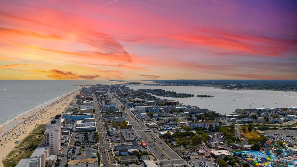Ocean City Maryland USA - 8 30 2025: Aerial shot of the hotels, amusement parks and shops on a peninsula with Atlantic ocean in Ocean City Maryland USA