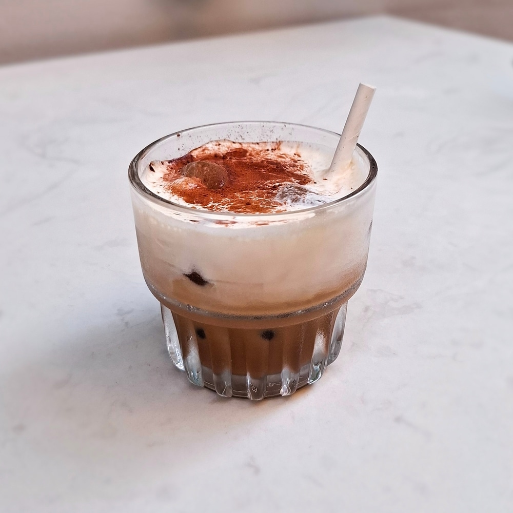 Traditional Vietnamese iced coffee with salty cream foam, served in a glass