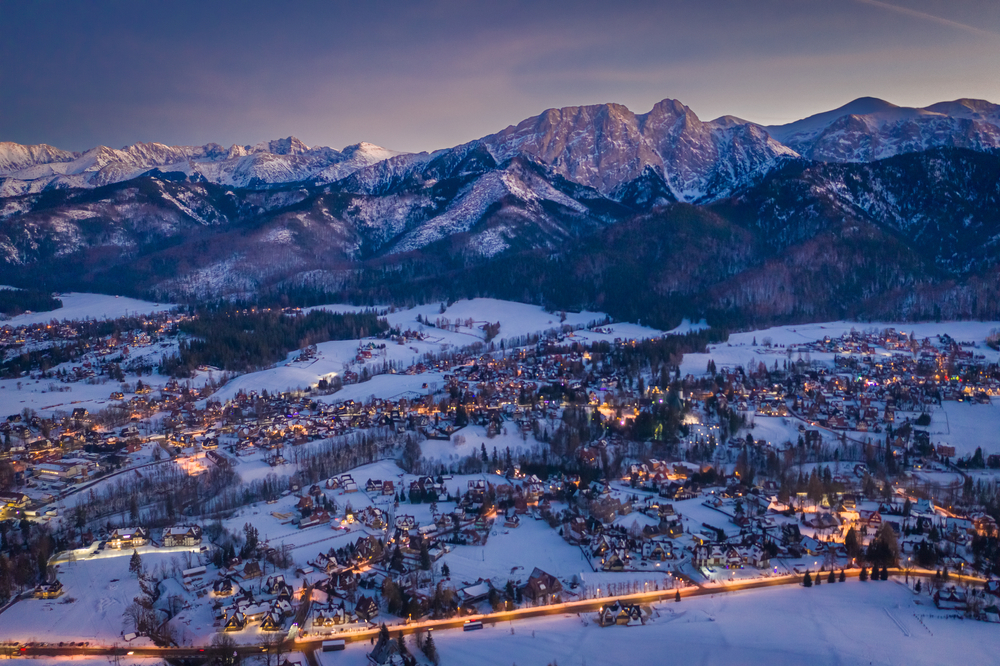 Stunning illuminated Zakopane city after dusk in winter, aerial view