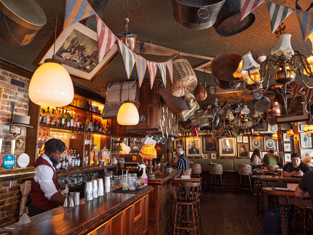London, UK - May 3, 2025: Interior of traditional wooden pub The Hat Tavern, Soho