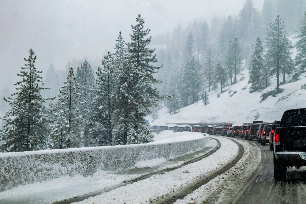 Sierra Nevada Mountains Winter Storm: A traffic jam on I-80 as automobiles (cars) and trucks line up at a chain control checkpoint between Truckee and Sacramento in Northern California near Lake Tahoe