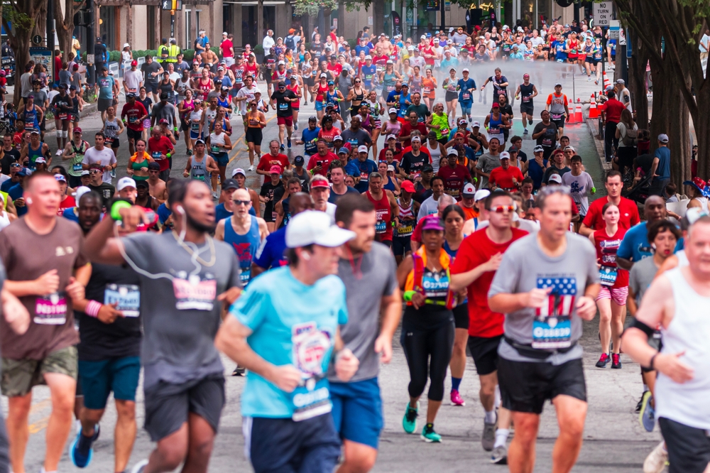 Atlanta, GA USA – July 4, 2023: Telephoto shot shows thousands of runners packing Peachtree Street at the annual Peachtree Road Race on July 4, 2023 in Atlanta, GA.