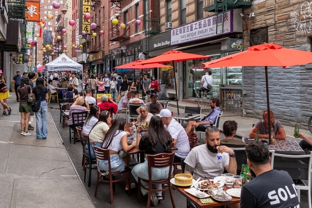 New York, USA - June 3rd 2024 - Photo showing the busy streets of Chinatown in New York City with signs in Chinese language.