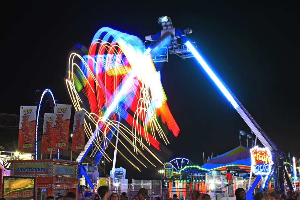 A shot of a colorful fair ride at night at the Kansas State Fair in Hutchinson Kansas USA that was on 9-18-2021 .