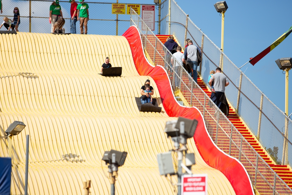 Puyallup, Washington, United States - 09-13-2021: A view of families enjoying the Giant Slide ride, seen at the Washington State Fair.