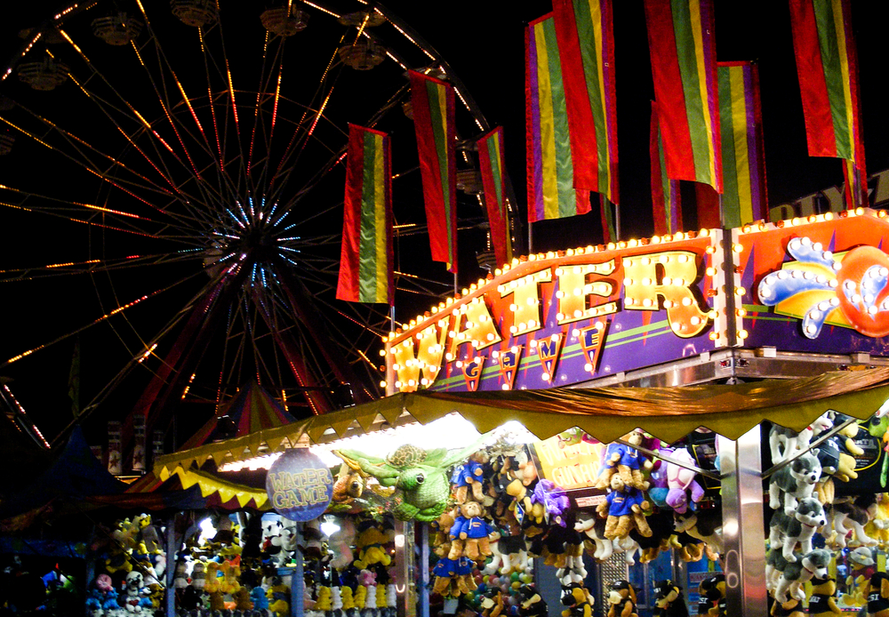 Tampa, Florida, USA - Feb 12, 2009: Water game and ferris wheel ride on the Florida State Fairgrounds.