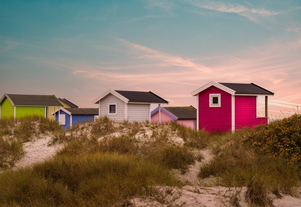 Colorful beach huts on beautiful white sand beach in Falsterbo, Sweden. Selective focus.