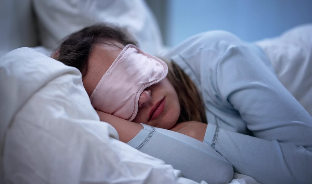 Peaceful Nurse Wears Eye Mask During Well-Deserved Power Nap After Shift.