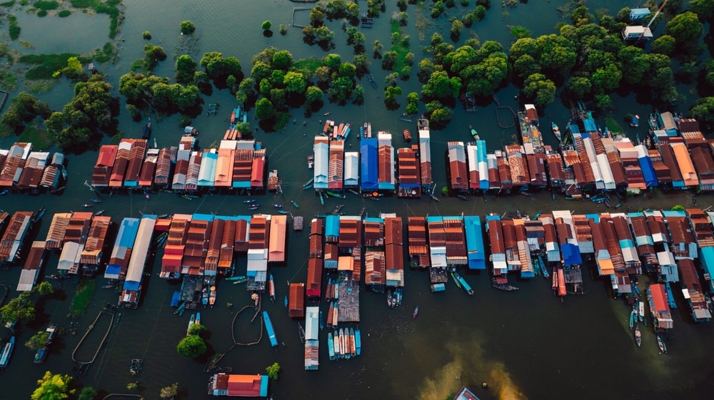 Kampong Phluk floating village with stilt houses on Tonle Sap lake in Cambodia.
